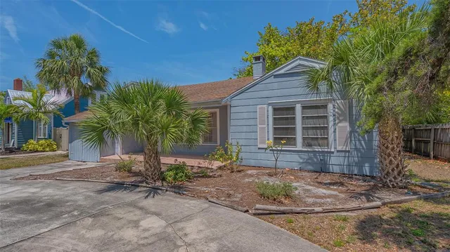a view of a house with backyard and sitting area