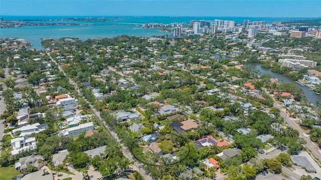 an aerial view of a house with a yard basket ball court and outdoor seating