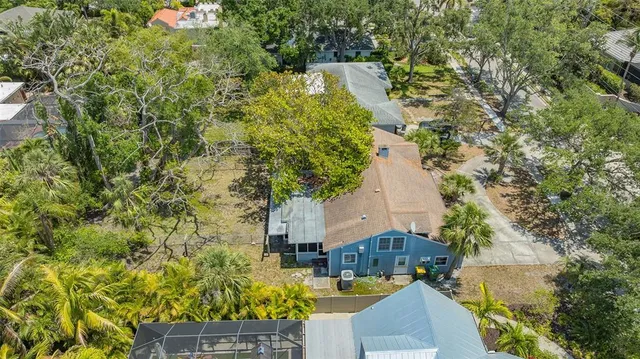 a view of a house with a yard and a wooden fence