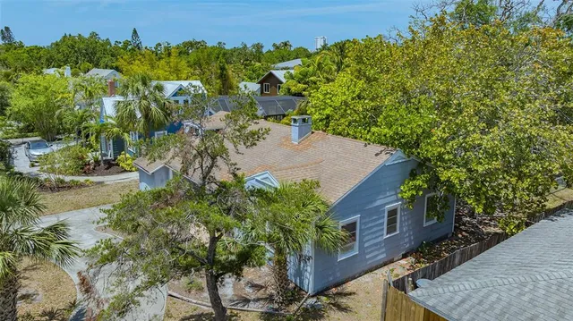 a front view of a house with a yard and tree s