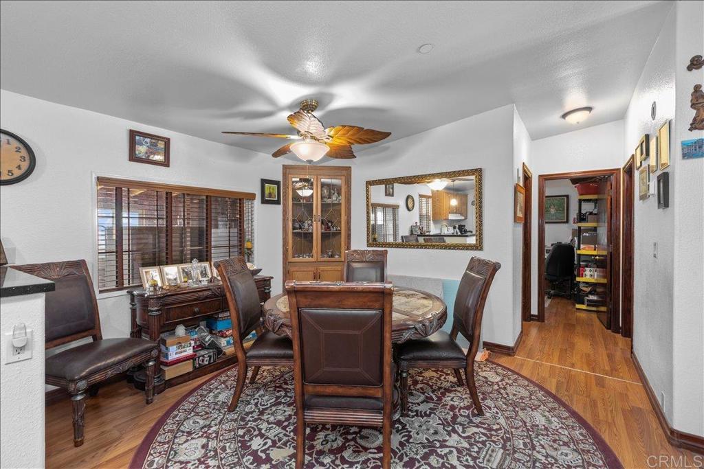 2285 Tierra Heights Road Boulevard, CA 91905 - Photo 14 of 51 a dining room with furniture and wooden floor