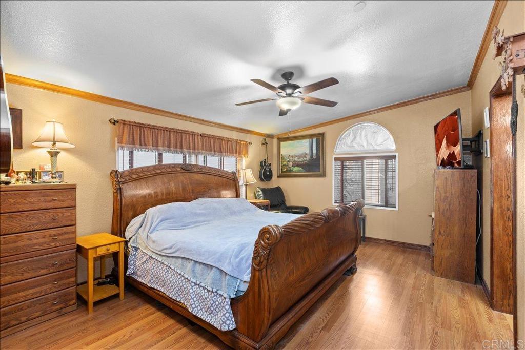 2285 Tierra Heights Road Boulevard, CA 91905 - Photo 15 of 51 a bedroom with a bed chandelier and a window