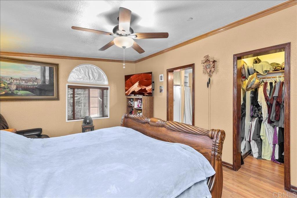 2285 Tierra Heights Road Boulevard, CA 91905 - Photo 16 of 51 a bedroom with a bed and a chandelier