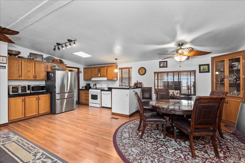 2285 Tierra Heights Road Boulevard, CA 91905 - Photo 9 of 51 a dining room with stainless steel appliances kitchen island granite countertop a table chairs and a refrigerator