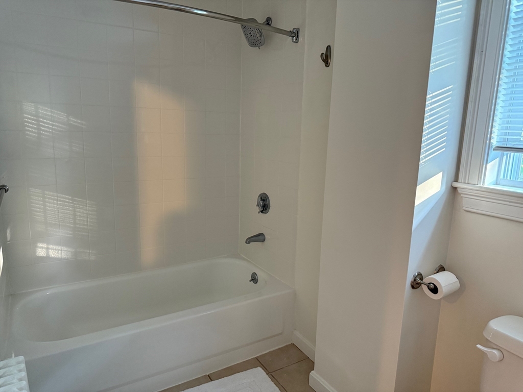 21 Denmark Avenue, Unit 2 Milton, MA 02186 - Photo 11 of 18 a bathroom with a bathtub