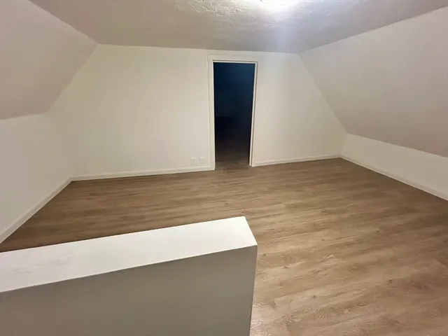 an empty room with wooden floor
