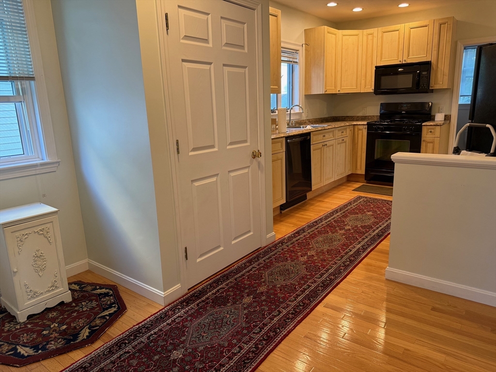 21 Denmark Avenue, Unit 2 Milton, MA 02186 - Photo 5 of 18 a kitchen with stainless steel appliances a refrigerator a stove top oven and sink