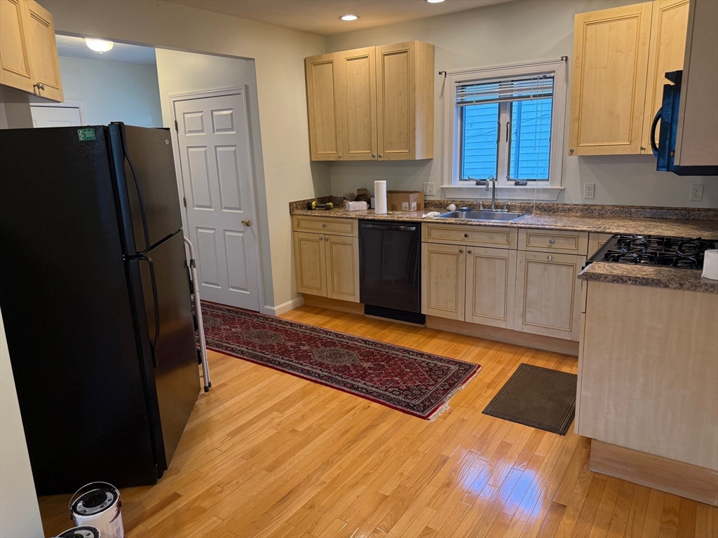 21 Denmark Avenue, Unit 2 Milton, MA 02186 - Photo 7 of 18 a kitchen with granite countertop a refrigerator stove and sink
