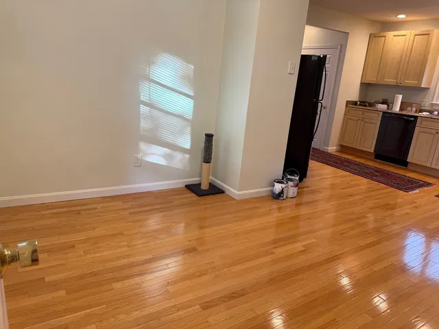 wooden floor in an empty room with a fireplace