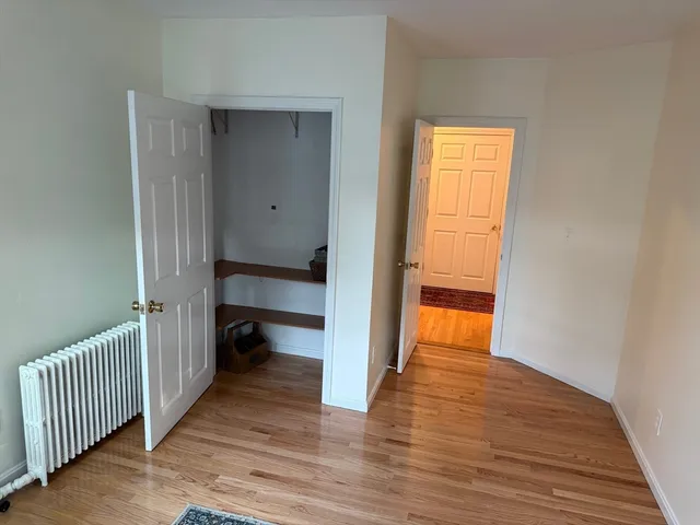 a view of a room with wooden floor