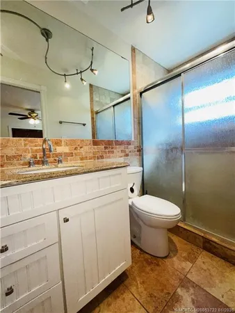a bathroom with a toilet sink and shower
