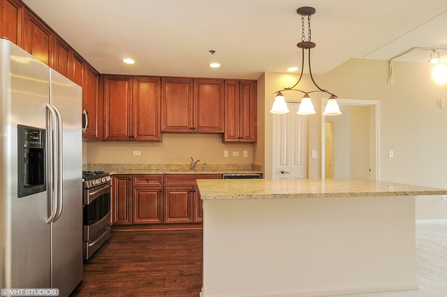 1199 East Port Clinton Road, Unit 208 Vernon Hills, IL 60061 - Photo 2 of 19 a kitchen with stainless steel appliances granite countertop a refrigerator a sink dishwasher a stove and white cabinets with wooden floor