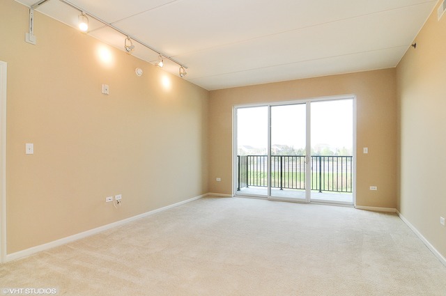 1199 East Port Clinton Road, Unit 208 Vernon Hills, IL 60061 - Photo 4 of 19 a view of an empty room with a window