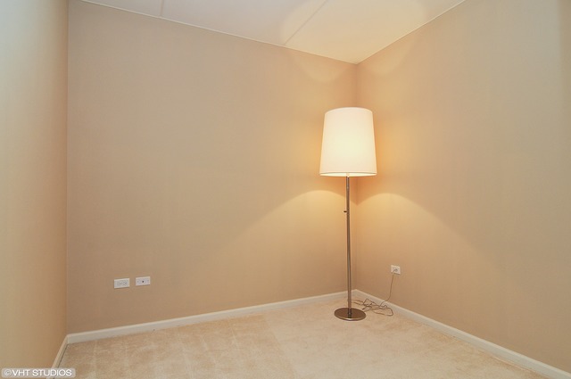 1199 East Port Clinton Road, Unit 208 Vernon Hills, IL 60061 - Photo 6 of 19 a room with a lamp and a table