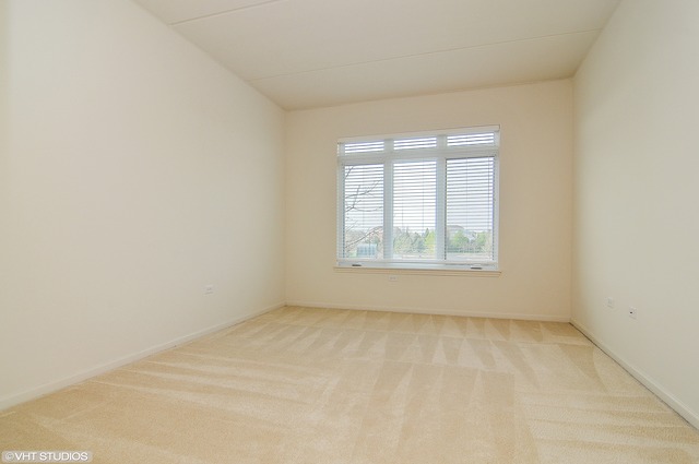 1199 East Port Clinton Road, Unit 208 Vernon Hills, IL 60061 - Photo 7 of 19 an empty room with a window