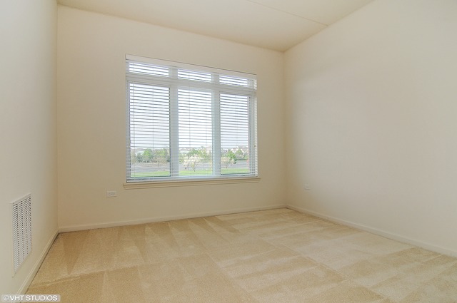 1199 East Port Clinton Road, Unit 208 Vernon Hills, IL 60061 - Photo 9 of 19 an empty room with a window