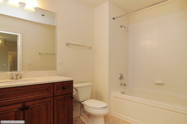 1199 East Port Clinton Road, Unit 208 Vernon Hills, IL 60061 - Photo 10 of 19 a bathroom with a sink a toilet and shower
