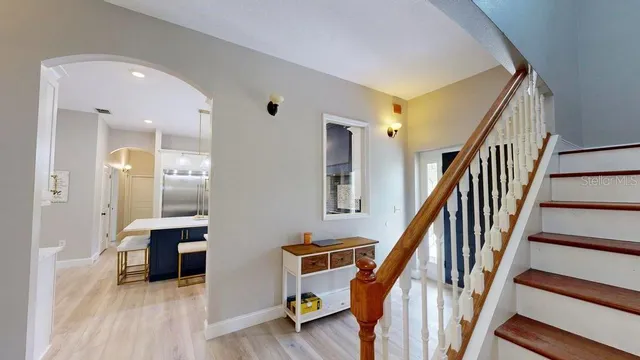 a large kitchen with a table chairs refrigerator and a stove