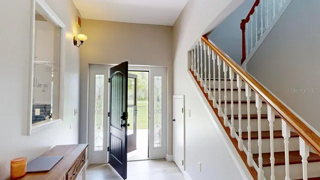 a view of a dining room with furniture wooden floor and chandelier