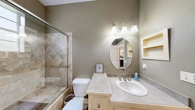 an aerial view of a house with garden space and a swimming pool