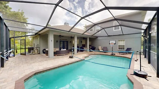 an aerial view of a house with yard swimming pool and outdoor seating