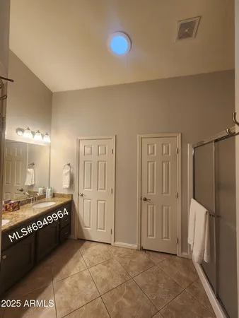 a bathroom with a double vanity sink and a mirror