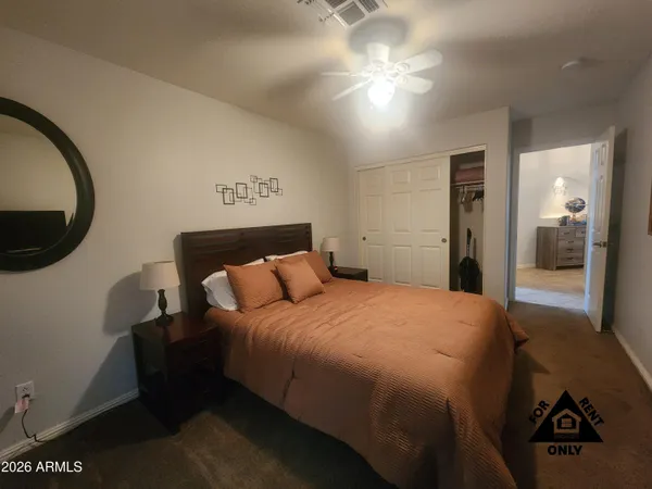 a bedroom with a bed and a mirror