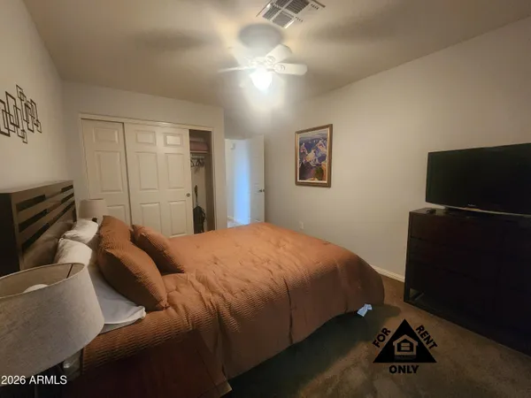 a bedroom with a bed and a television