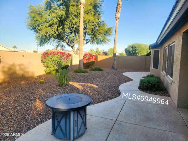 a view of a patio with table and chairs potted plants
