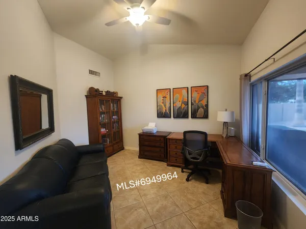 a living room with furniture and a piano