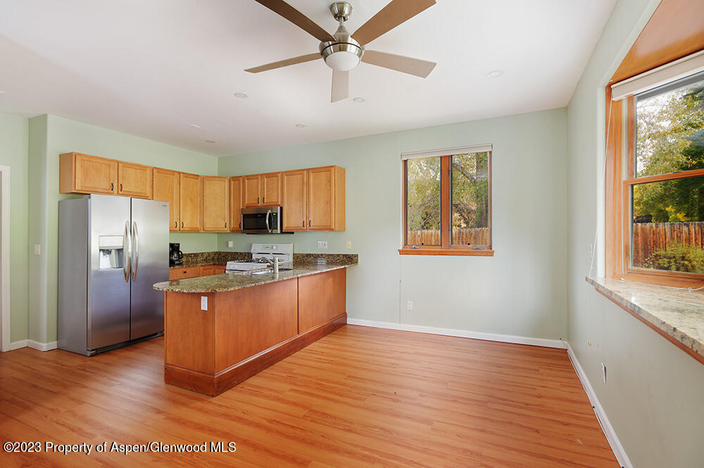 330 Alexander Lane Basalt, CO 81621 - Photo 4 of 10 a kitchen with stainless steel appliances granite countertop a refrigerator a stove a sink and a window