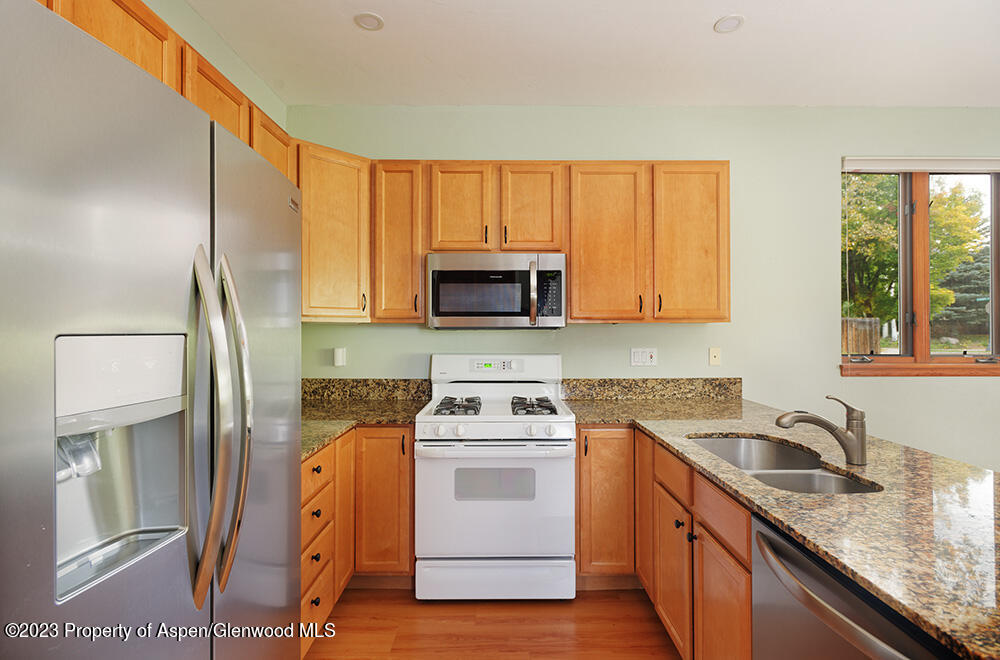 330 Alexander Lane Basalt, CO 81621 - Photo 5 of 10 a kitchen with stainless steel appliances granite countertop a sink stove and microwave
