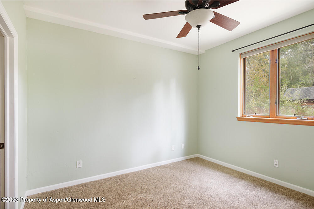 330 Alexander Lane Basalt, CO 81621 - Photo 8 of 10 an empty room with a window and a chandelier fan