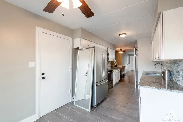 a kitchen with refrigerator and window