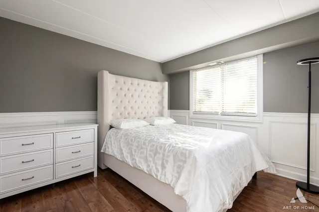 a bedroom with a large bed and a window