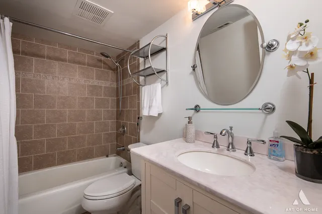 a bathroom with a sink toilet and a mirror