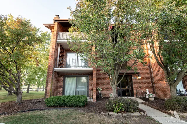 a front view of a house with a tree