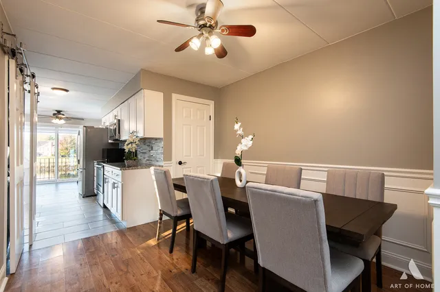 a view of a dining room with furniture and wooden floor