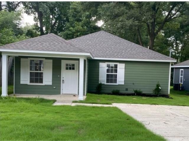 3554 Kruger Road Memphis, TN 38108 - Photo 1 of 10 a view of a brick house with a yard potted plants and a table
