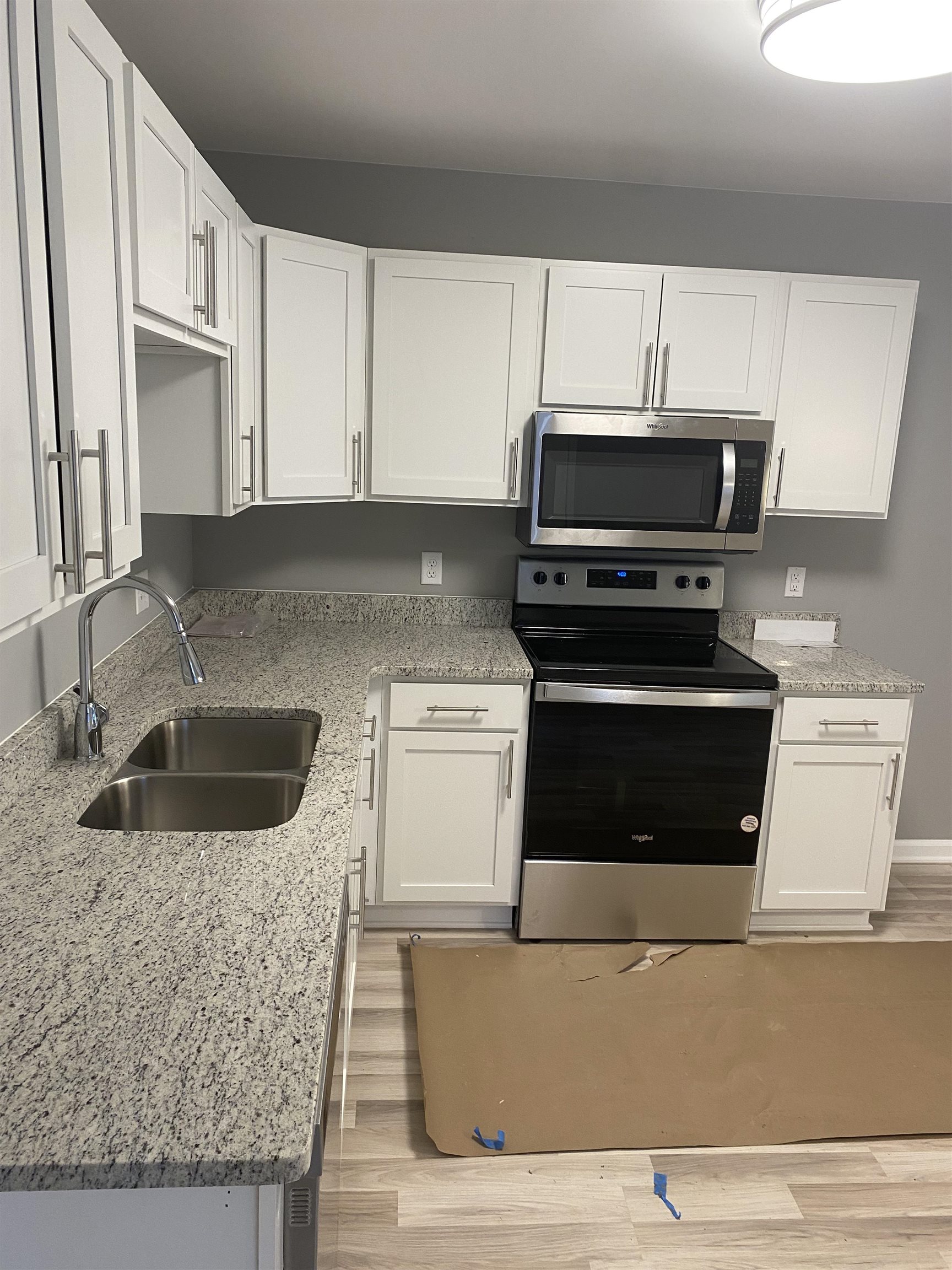 3554 Kruger Road Memphis, TN 38108 - Photo 6 of 10 a kitchen with granite countertop a sink a stove and microwave