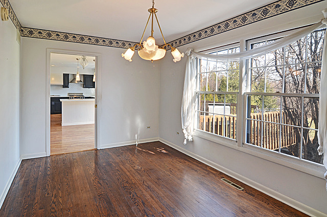 851 South County Line Road Hinsdale, IL 60521 - Photo 4 of 25 a view of a room with wooden floor and windows