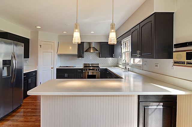 851 South County Line Road Hinsdale, IL 60521 - Photo 5 of 25 a kitchen with stainless steel appliances a sink a stove a refrigerator a sink a stove with wooden floor and cabinets