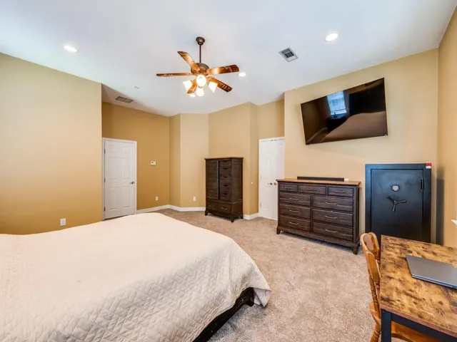 a bedroom with a bed and flat screen tv