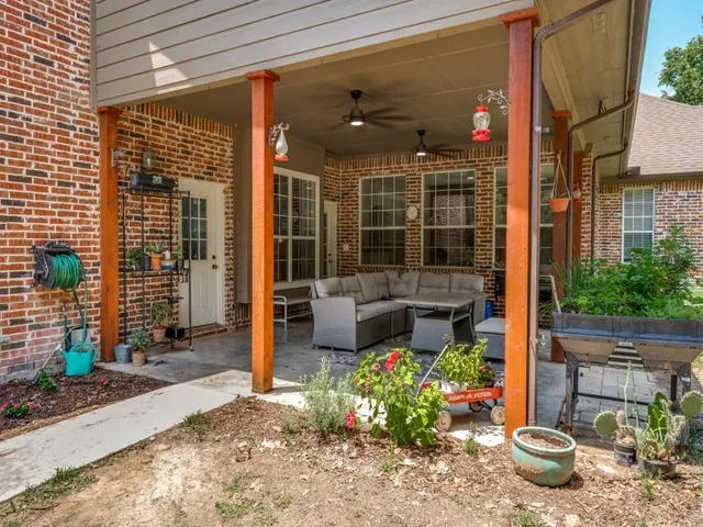 a living room filled with furniture and a potted plant