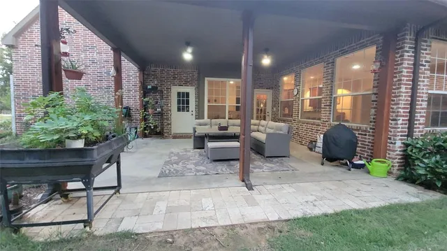 a living room filled with furniture and a floor to ceiling window
