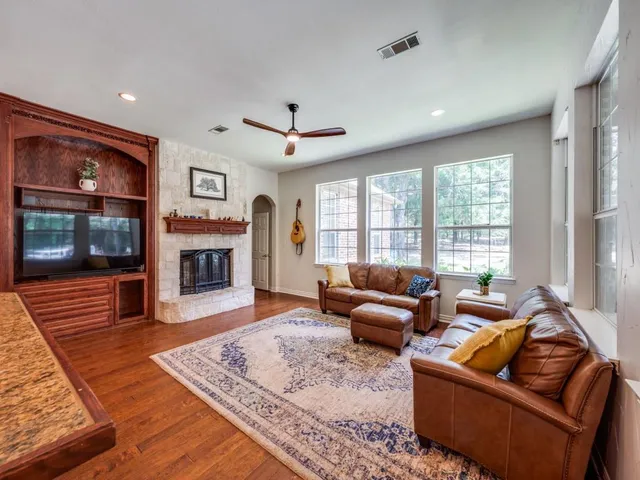 a living room with furniture flat screen tv and a fireplace