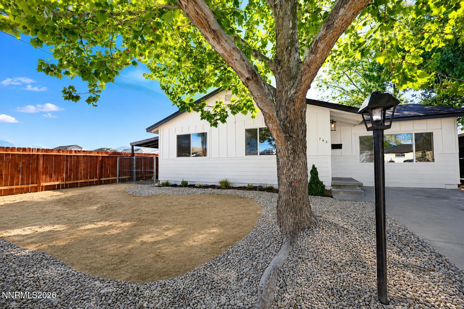 742 Ruth Street Carson City, NV 89701 - Photo 1 of 25 a view of a house with a tree in the yard