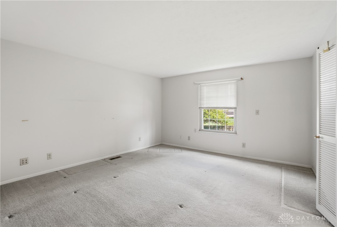 9964 Hummingbird Way Dayton, OH 45458 - Photo 30 of 57 This spacious room offers a blank canvas for personalization, featuring soft carpeting and a window for natural light.