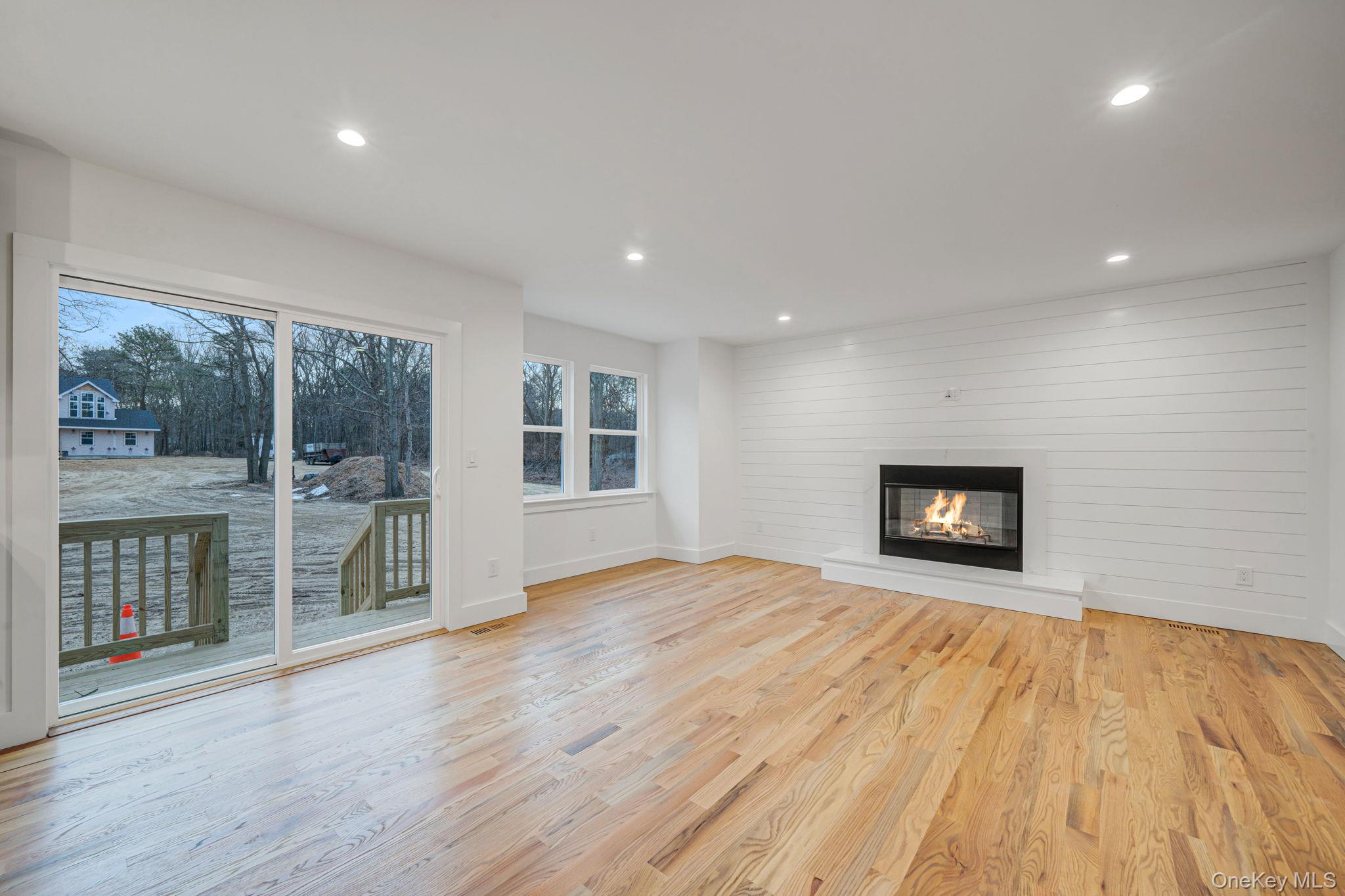 63 A Blydenburgh Road Centereach, NY 11720 - Photo 11 of 38 a view of an empty room with a window and wooden floor