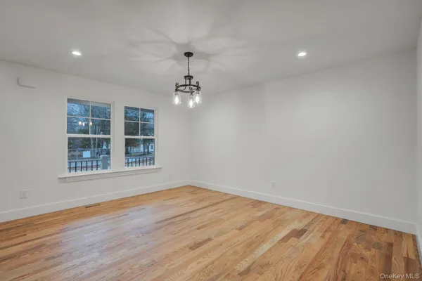 an entryway in a room with wooden floor and stairs